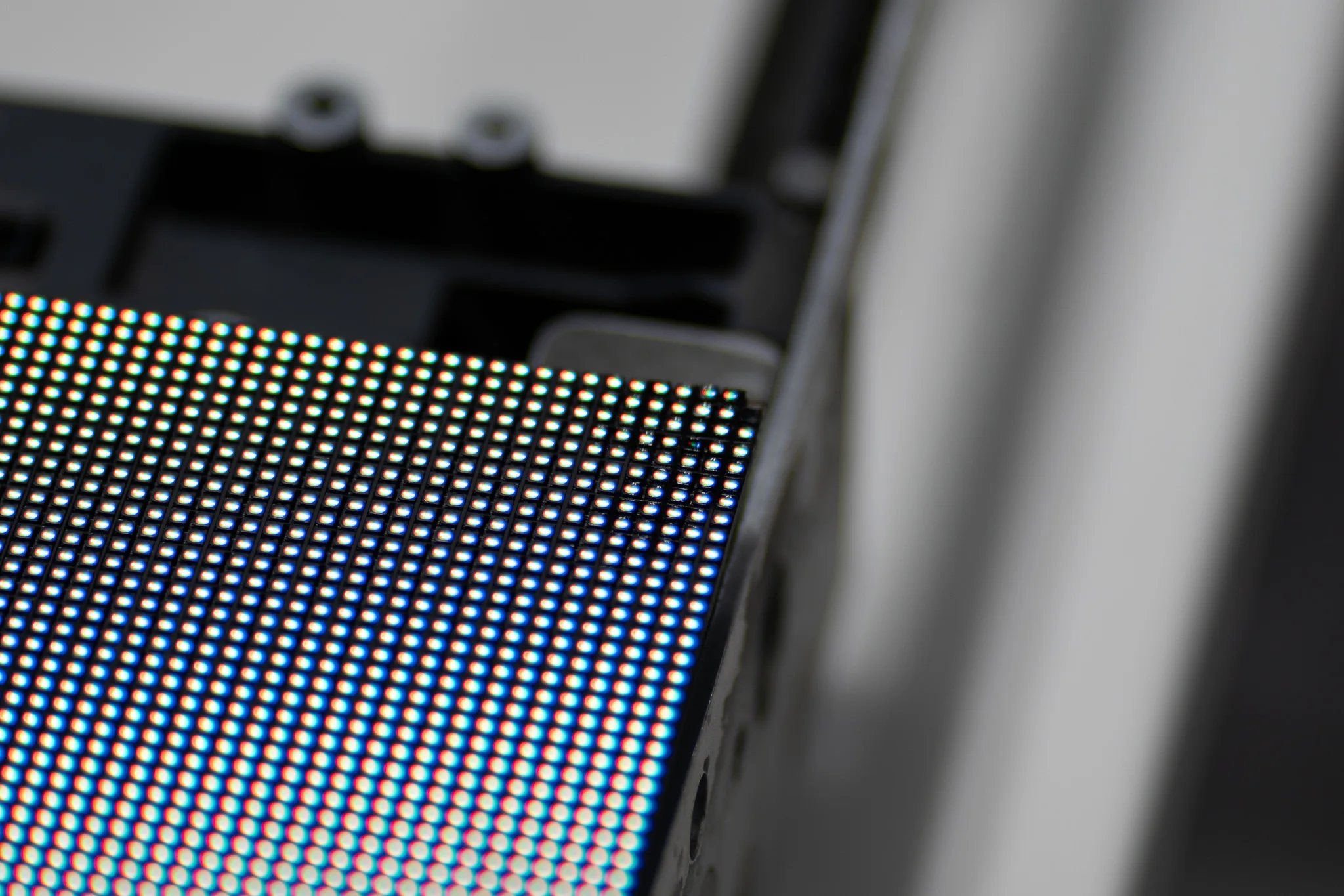 Close-up of an LED display module showing individual RGB diodes in a dense grid pattern.