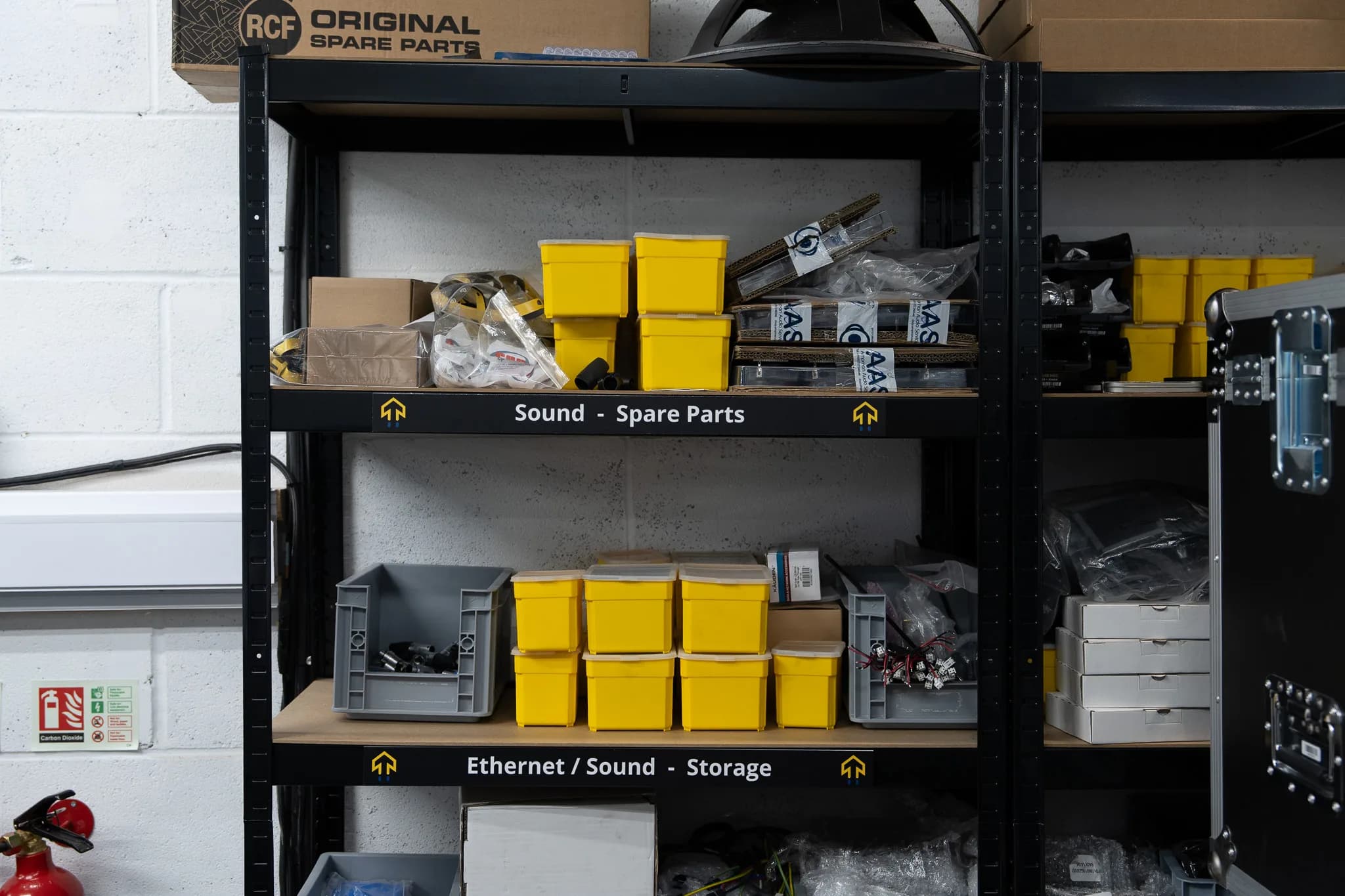 Labelled warehouse shelving of sound spare parts in bins and boxes