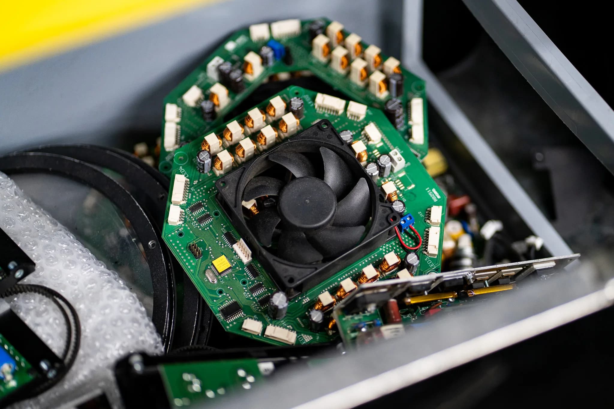 Cooling fan mounted on the circular driver boards inside an opened moving light head